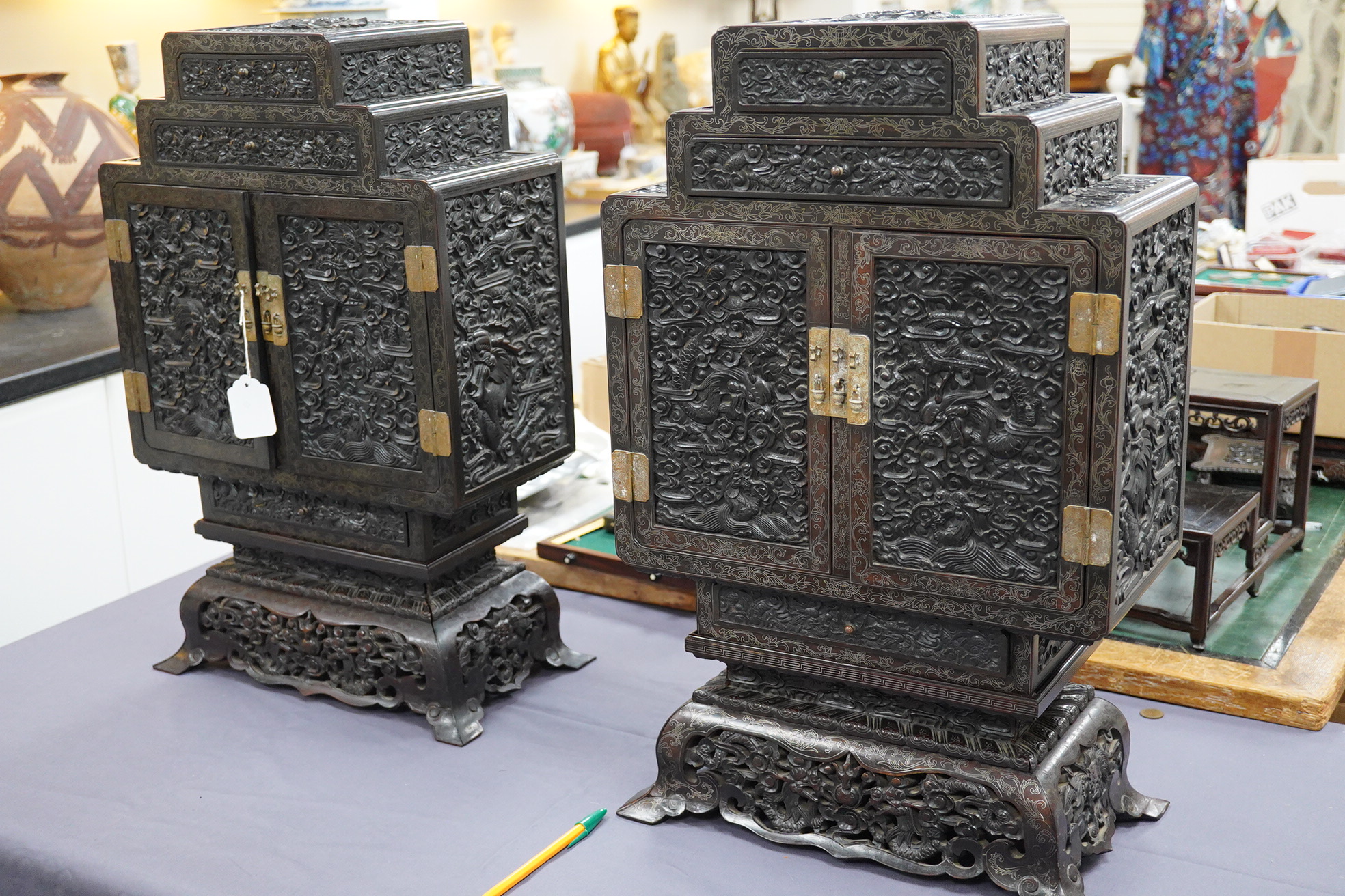 An important pair of Chinese carved zitan and silver wire inlaid ‘cloud and dragon’ curio cabinets and stands, duobaoge, probably Imperial, late Qing dynasty